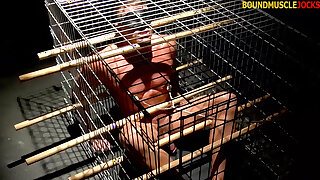 Husky man Tyler Saint gets blindfolded and caged